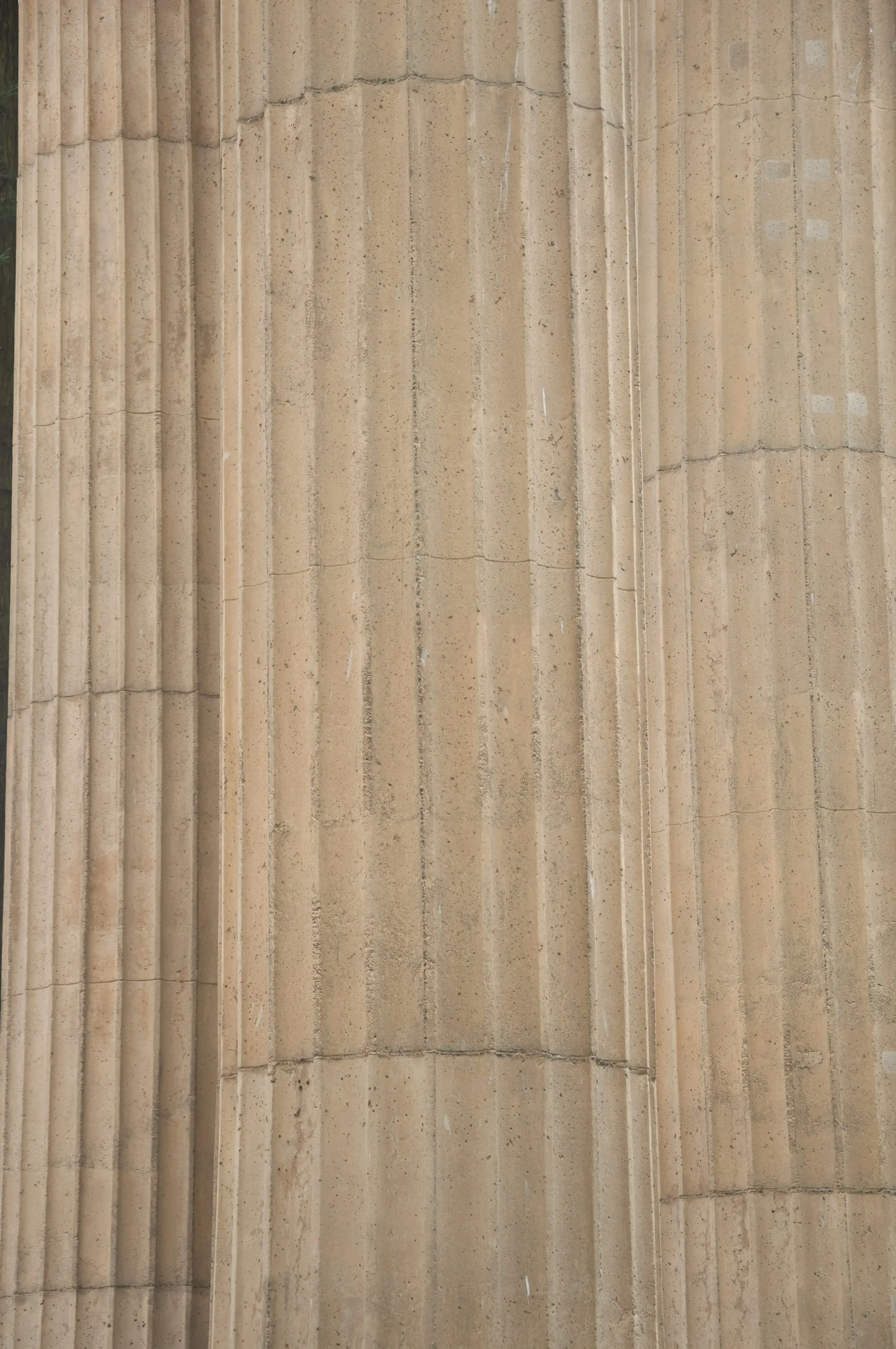 Close view of a fluted marble column in warm raking light