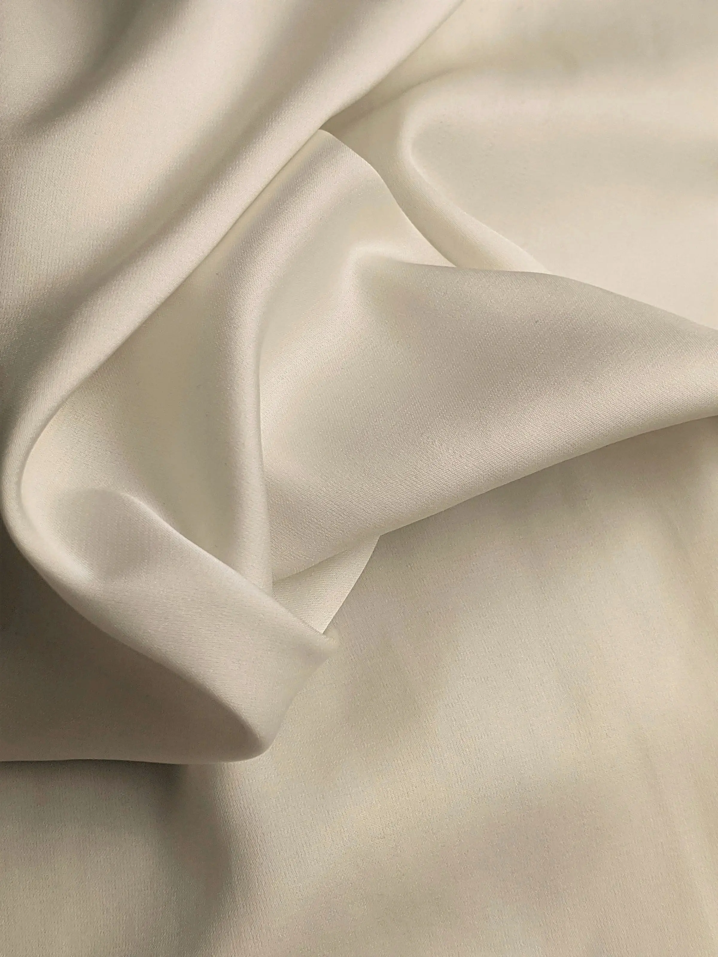 Cream silk falling in soft, heavy folds